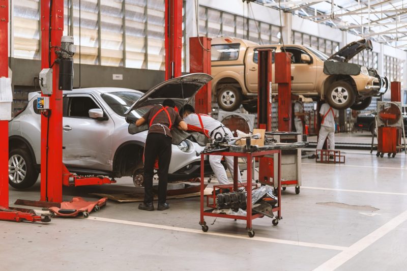 interior-car-repair-garage-service-station Interior of a car repair in garage service station with soft-focus and over light in the background